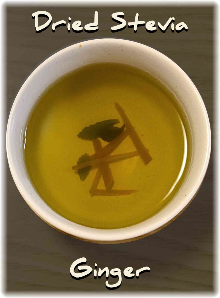 木製のテーブルの上に置かれた乾燥ステビアと生姜の温かい飲み物